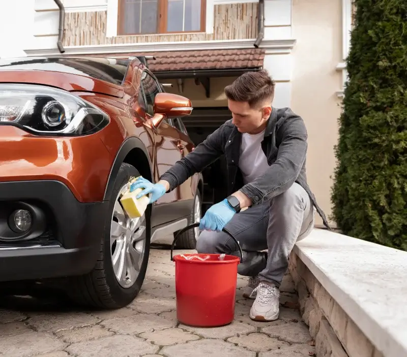 Lavage auto à domicile Igé : professionnel intervenant sur un véhicule